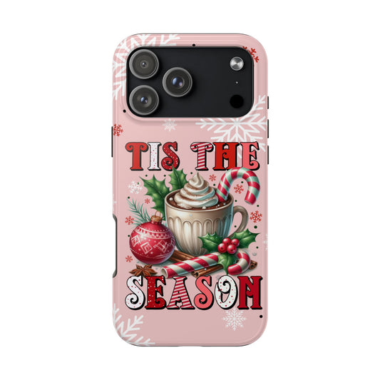 Phone case with Christmas design featuring 'Tis the Season text and festive elements on a pink background.